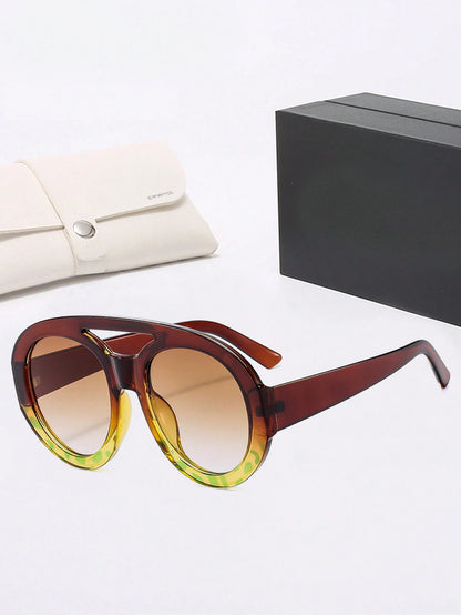 Sunglasses with a gradient design on a white surface with a black box and beige pouch.