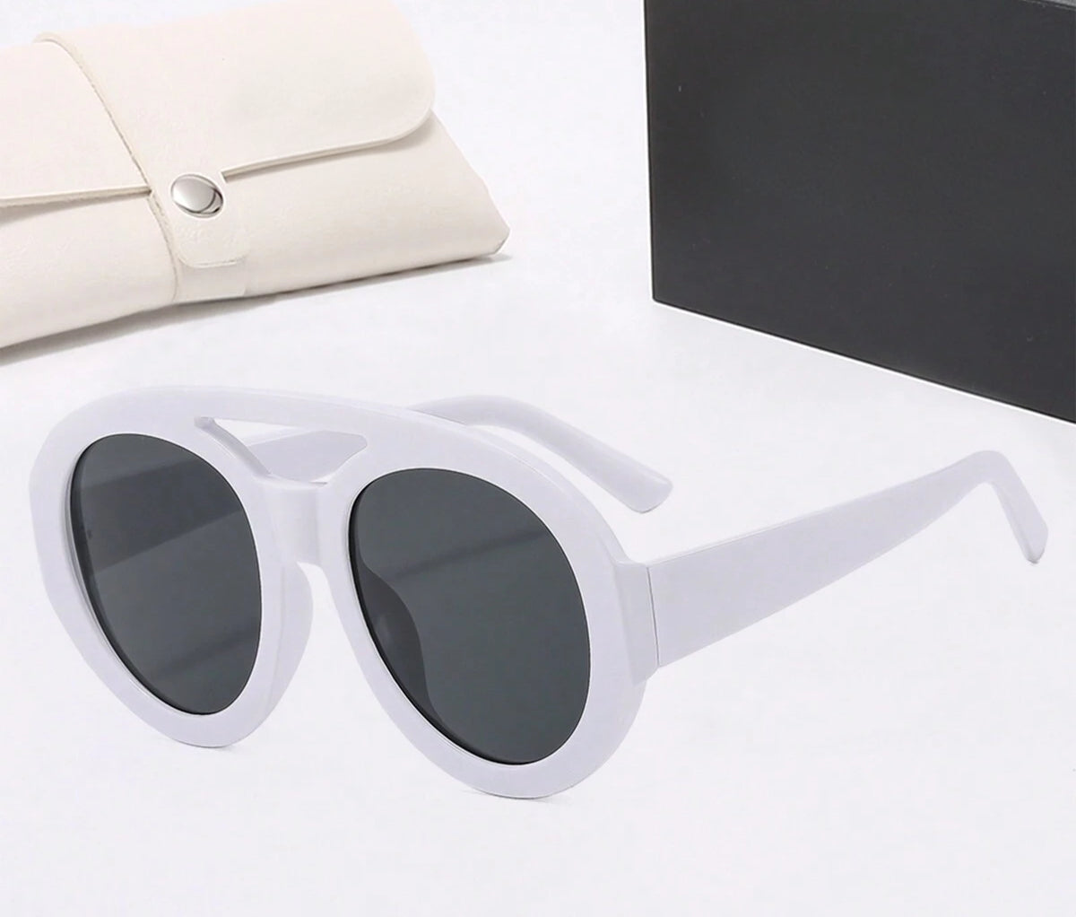 White sunglasses with dark lenses on a light surface