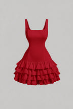 A red sleeveless mini dress with a square neckline, tiered and ruffle hem, and a natural waistline.
