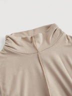 Close-up of beige fabric with a plain background