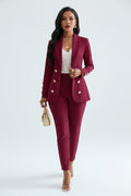 Woman in a red suit standing in a bedroom