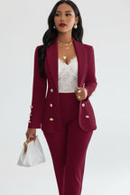 Woman in a red suit standing in a bedroom