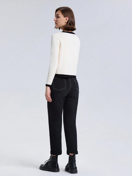 Person wearing a white top and black pants on a light gray background