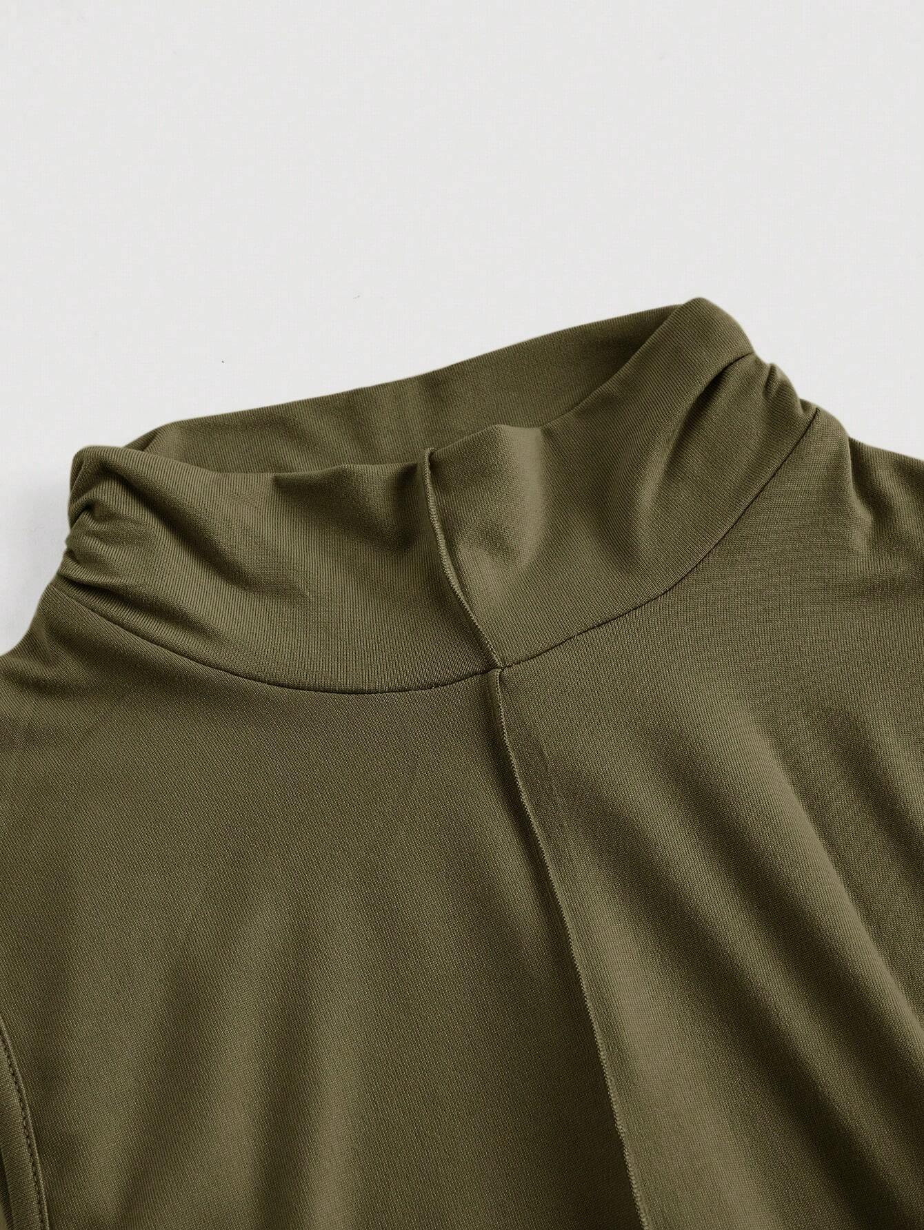 Close-up of a green sleeveless top with a high neckline on a light gray background