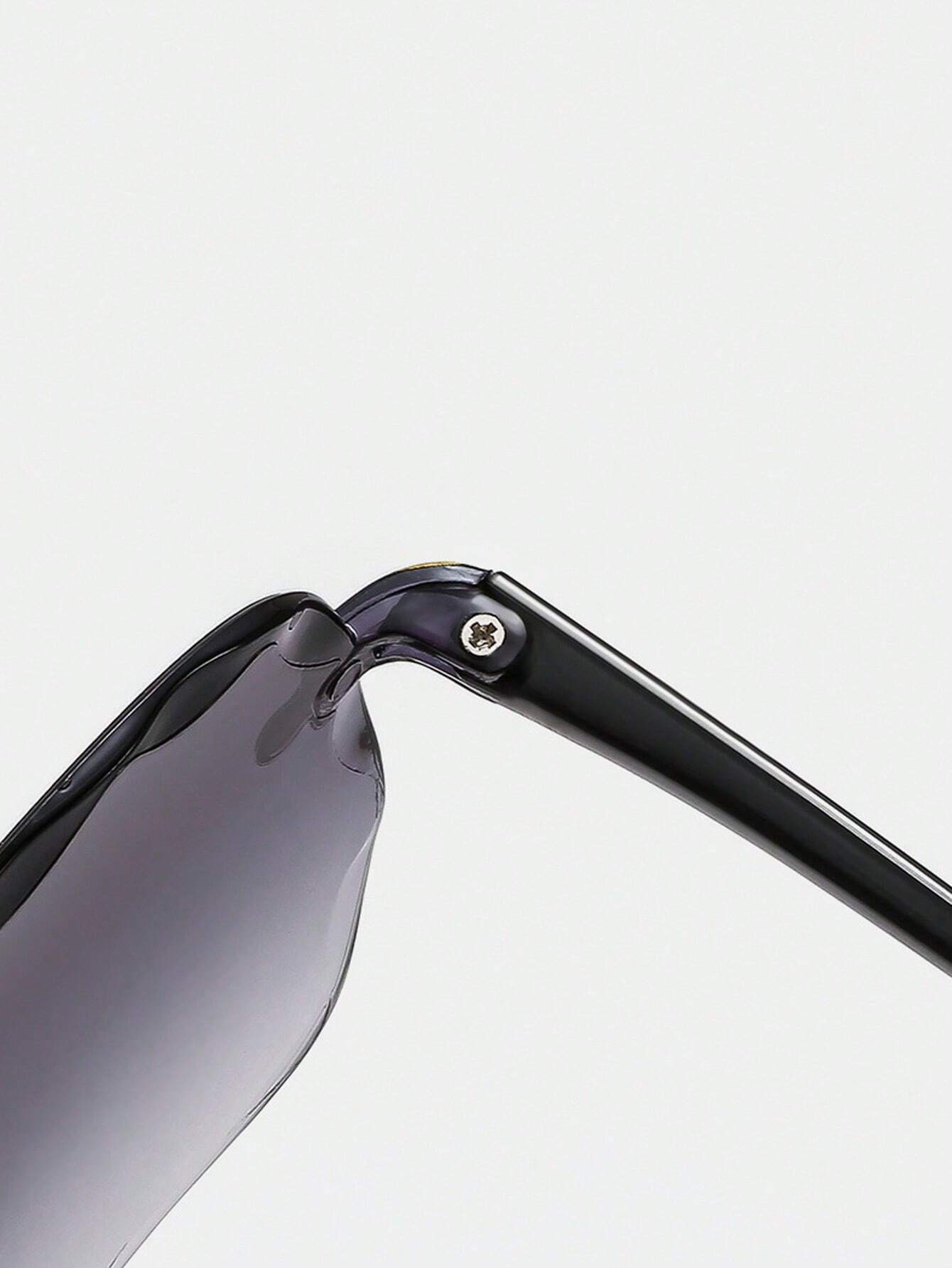 Close-up of a sunglasses frame with a reflective lens on a light gray background