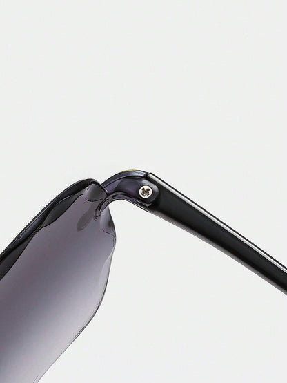 Close-up of a sunglasses frame with a reflective lens on a light gray background