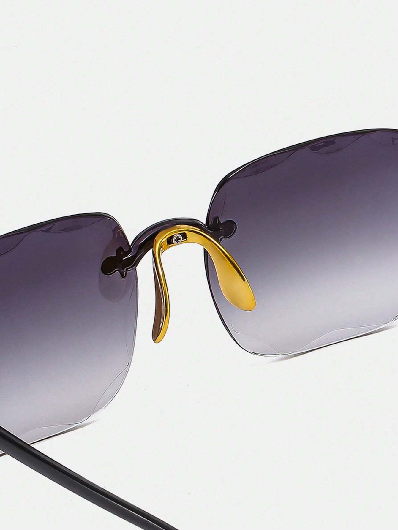 Sunglasses with gradient lenses and gold frame on a white background