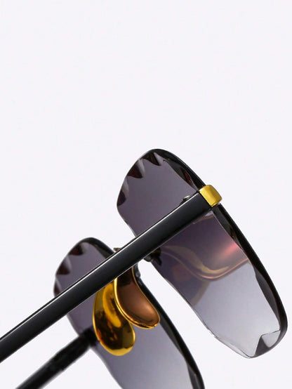 Sunglasses with black frame, gold accents, and dark lenses on a light gray background