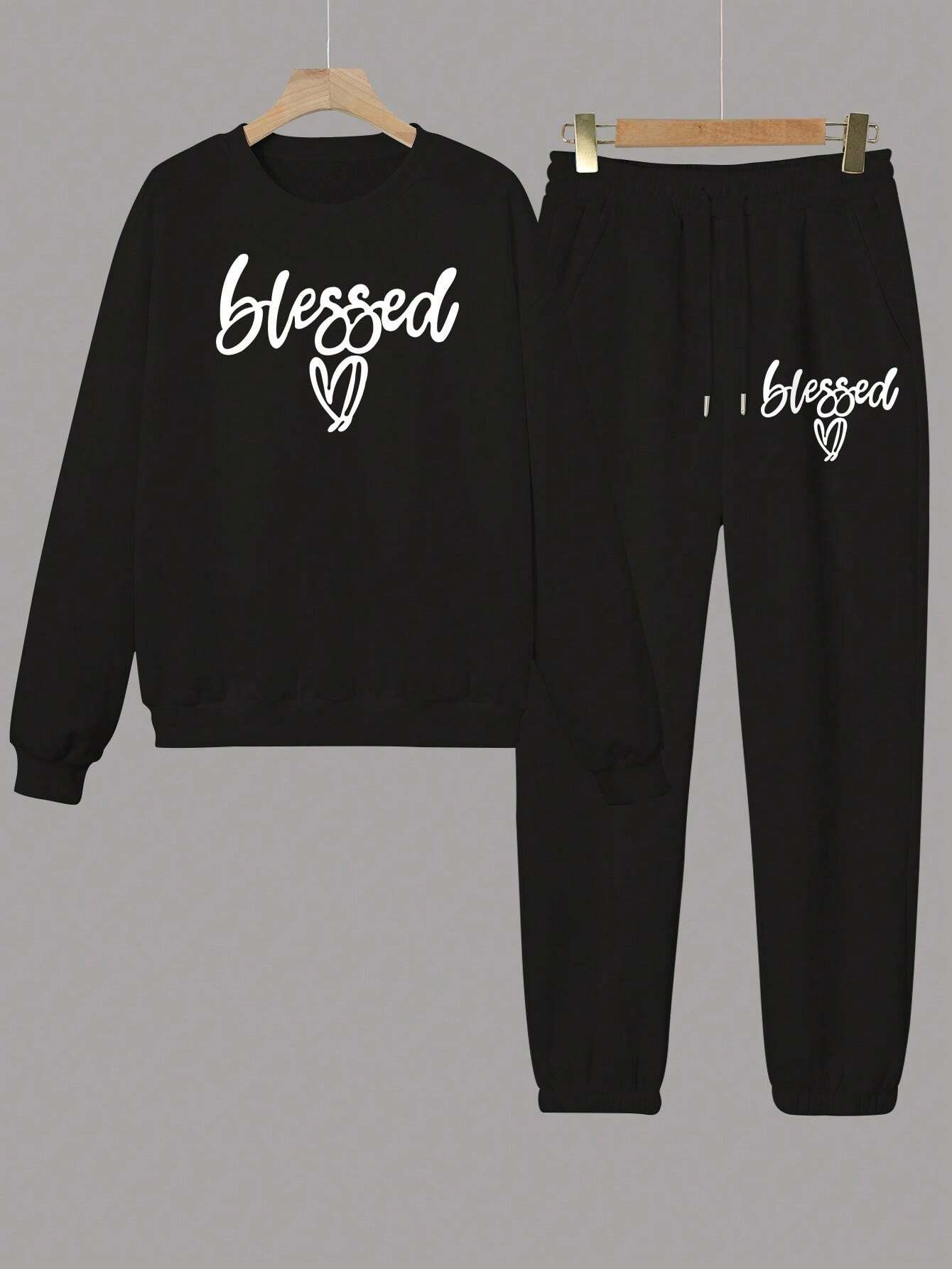Black sweatshirt and pants set with 'blessed' text on a gray background