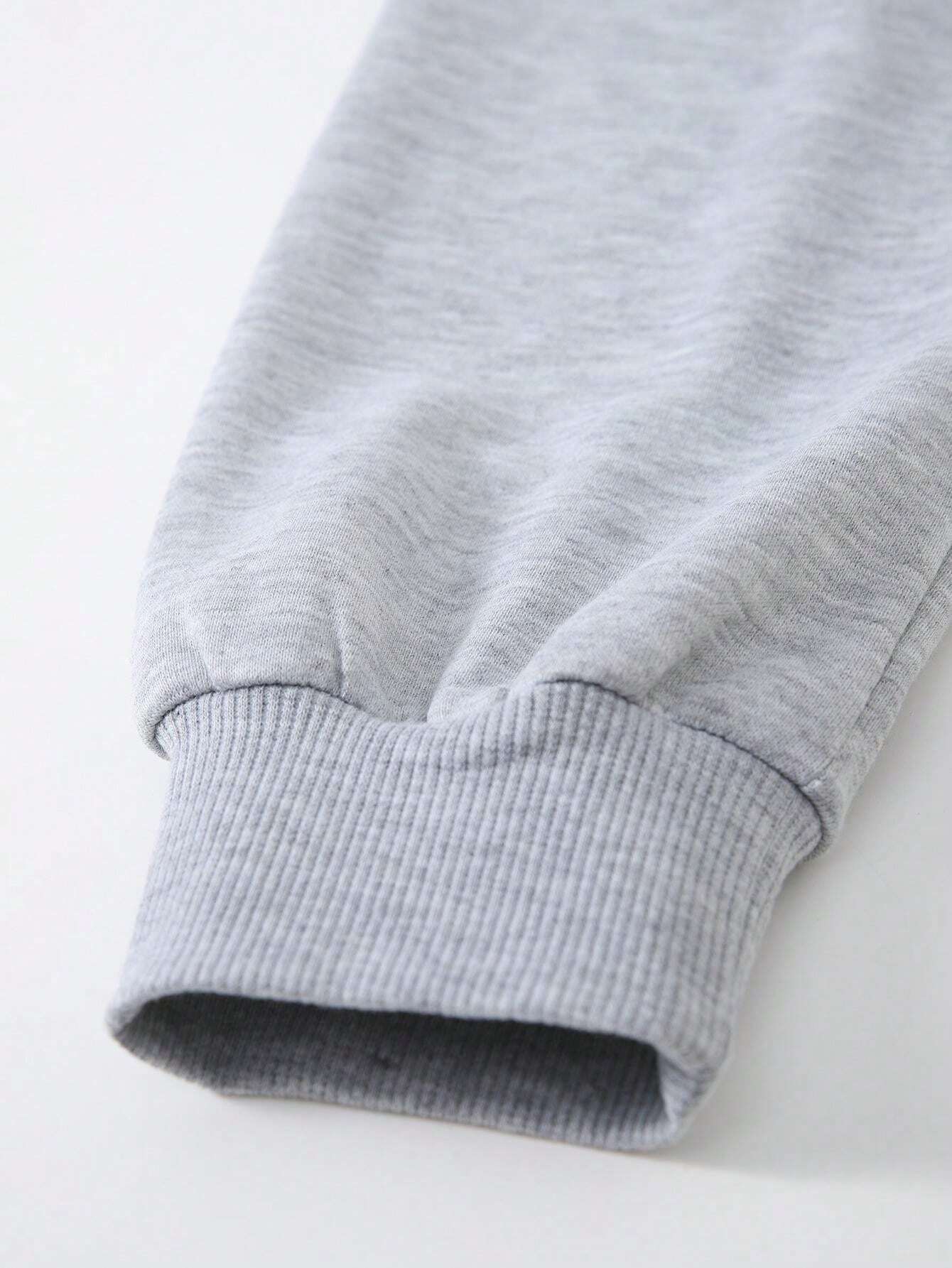 Close-up of a gray sweatshirt with ribbed cuffs on a white background