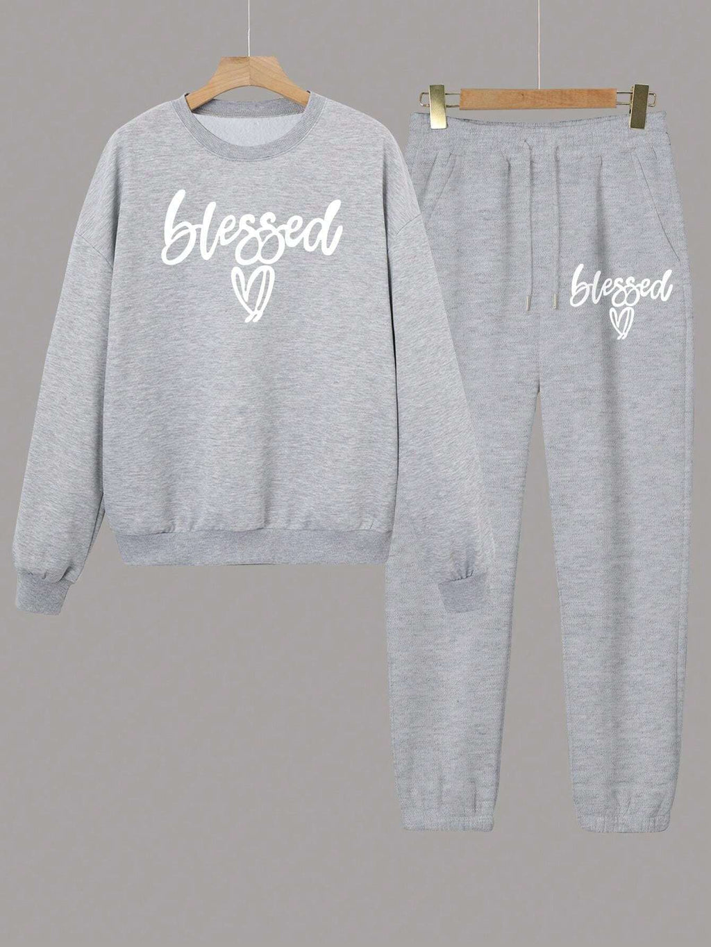 Gray sweatshirt and pants set with 'blessed' text on a gray background