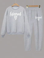 Gray sweatshirt and pants set with 'blessed' text on a gray background