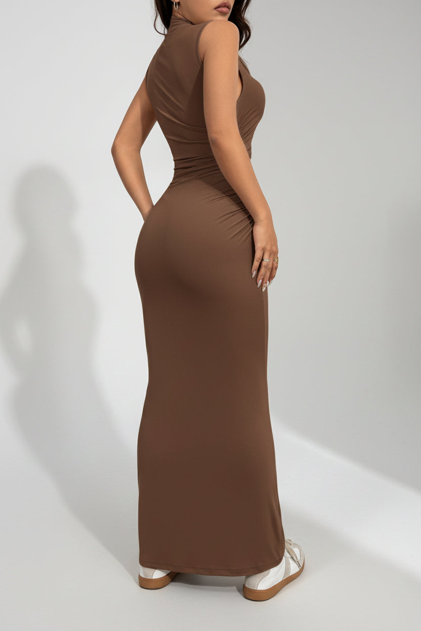 Woman wearing a brown sleeveless dress against a white backgroundl.