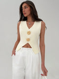 Woman wearing a cream-colored sleeveless top with decorative buttons on a plain background