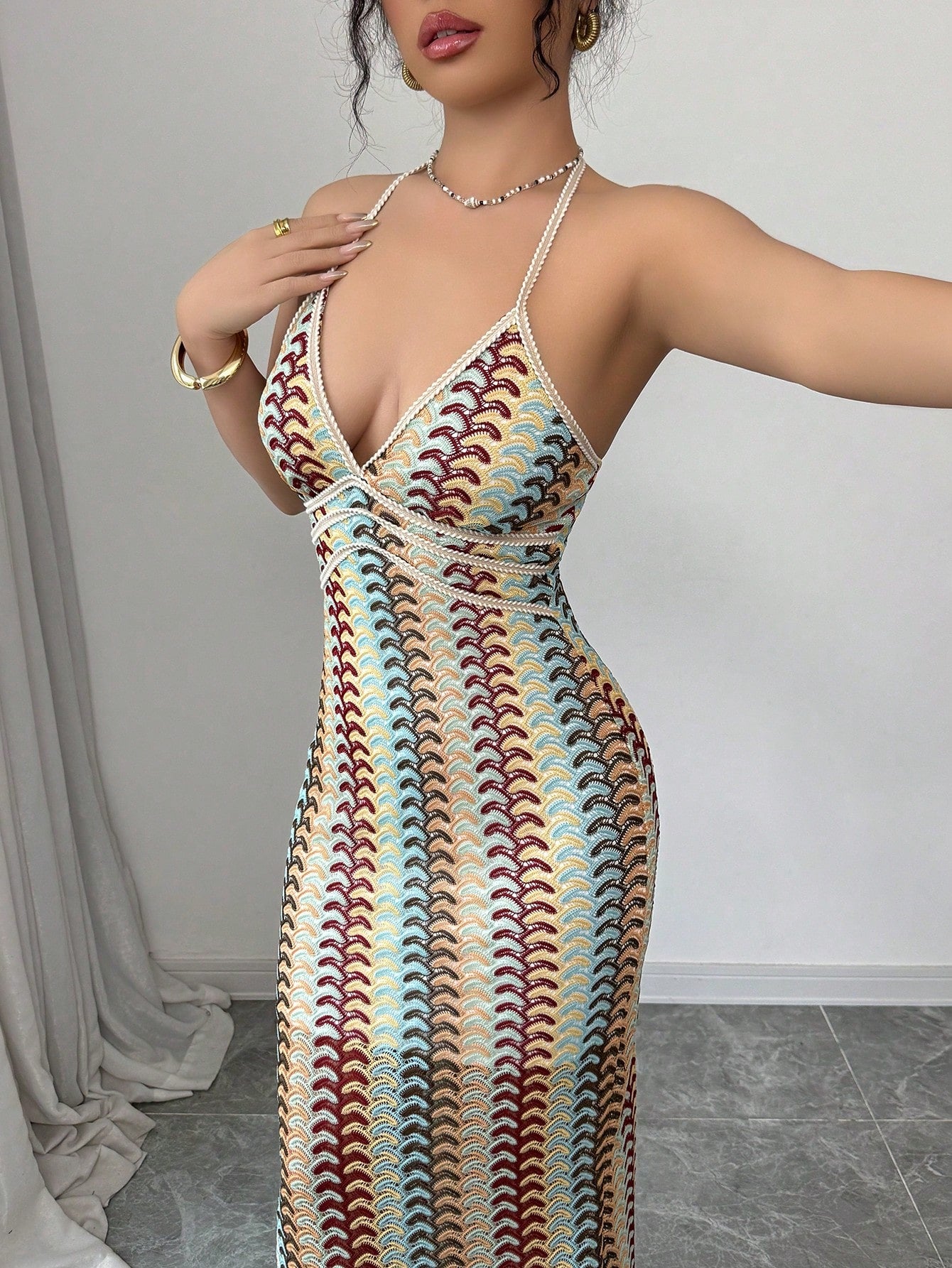 Woman wearing a patterned dress with a plain background