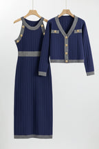 Navy blue dress with gray trim on wooden hangers against a white background