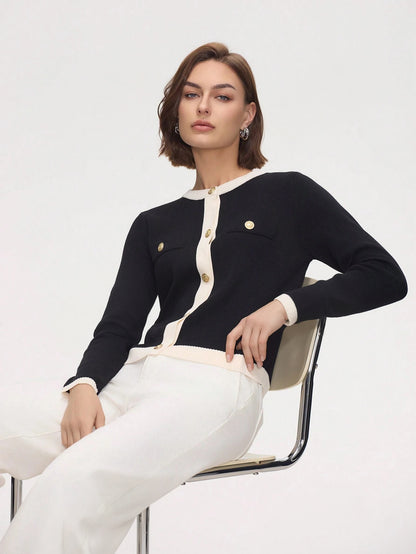 Woman wearing a black and white outfit with gold buttons on a white background