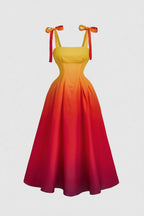 Yellow to red gradient dress with bow straps on a light gray background