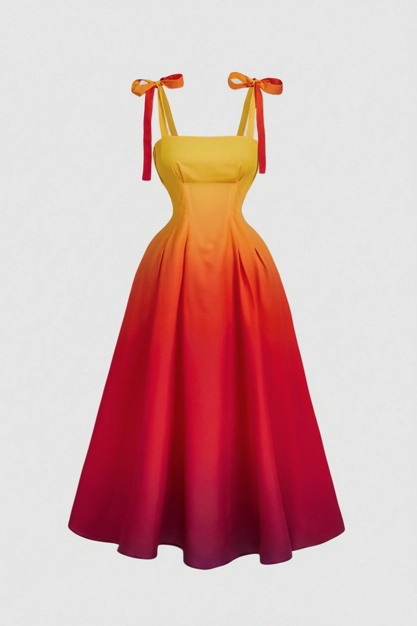 Yellow to red gradient dress with bow straps on a light gray background
