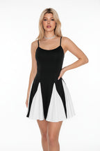 Woman wearing a black and white dress in an indoor setting