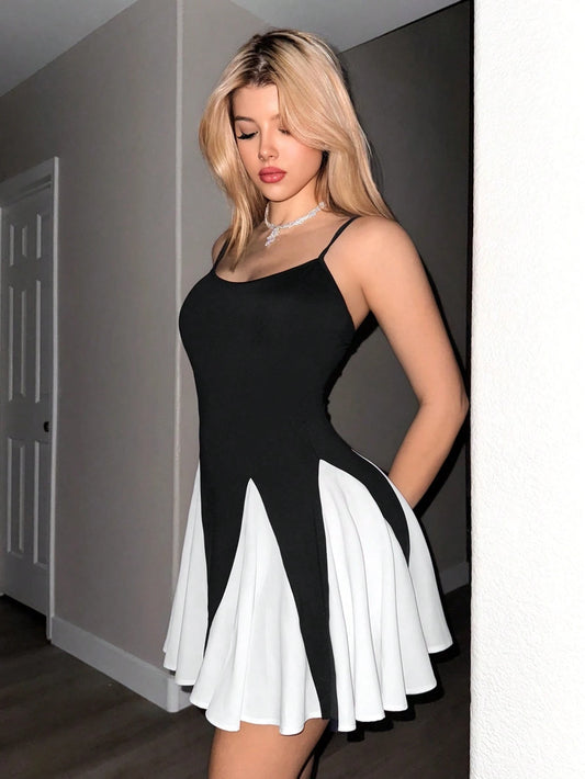 Woman wearing a black and white dress in an indoor setting