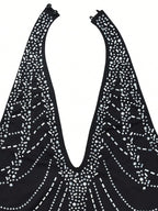 Black top with white rhinestone pattern on a white background