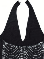 Black tank top with decorative silver beads on a white background