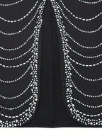 Black fabric with white bead patterns on a black background