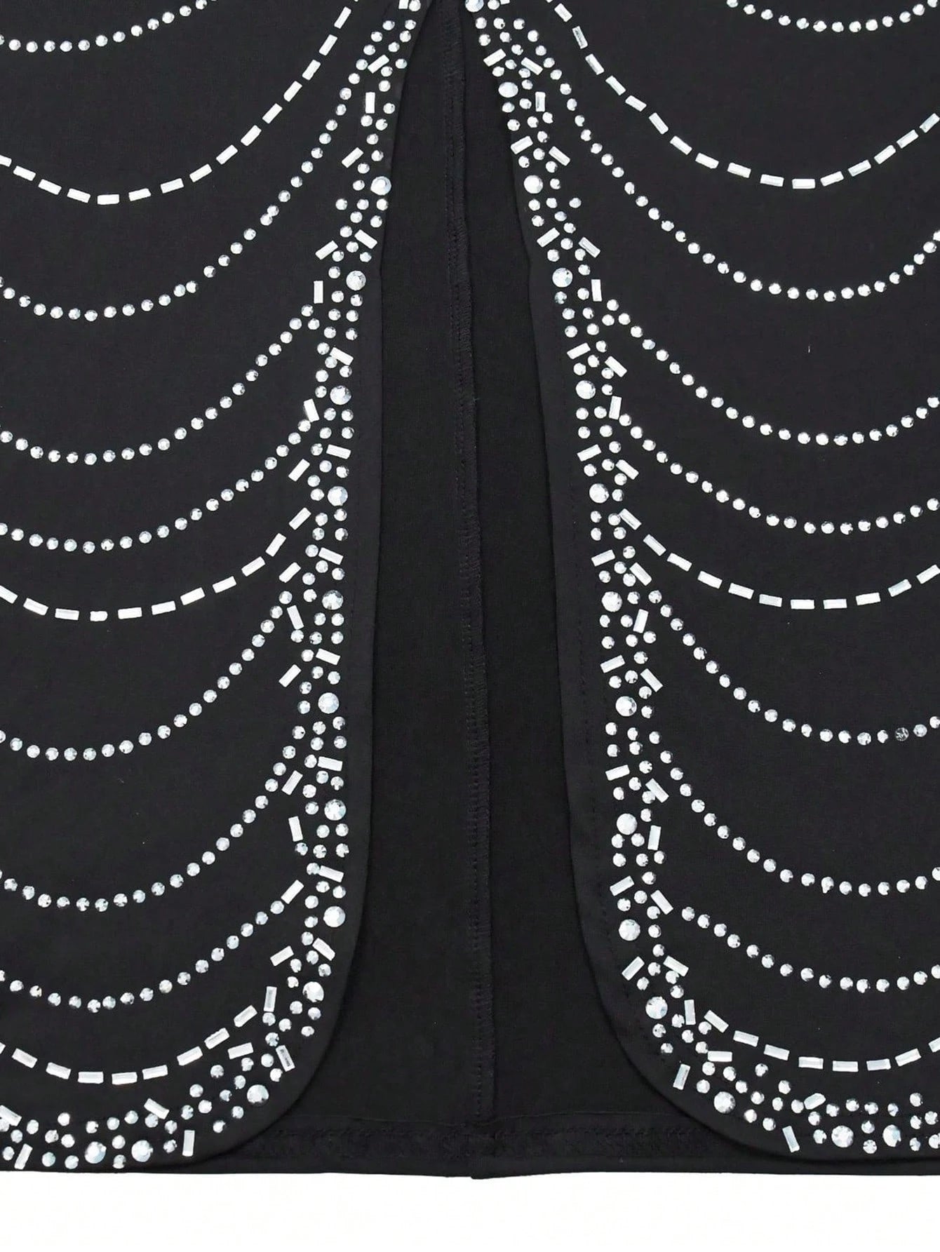Black fabric with white bead patterns on a black background