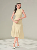 Woman wearing a light yellow dress with a plain background