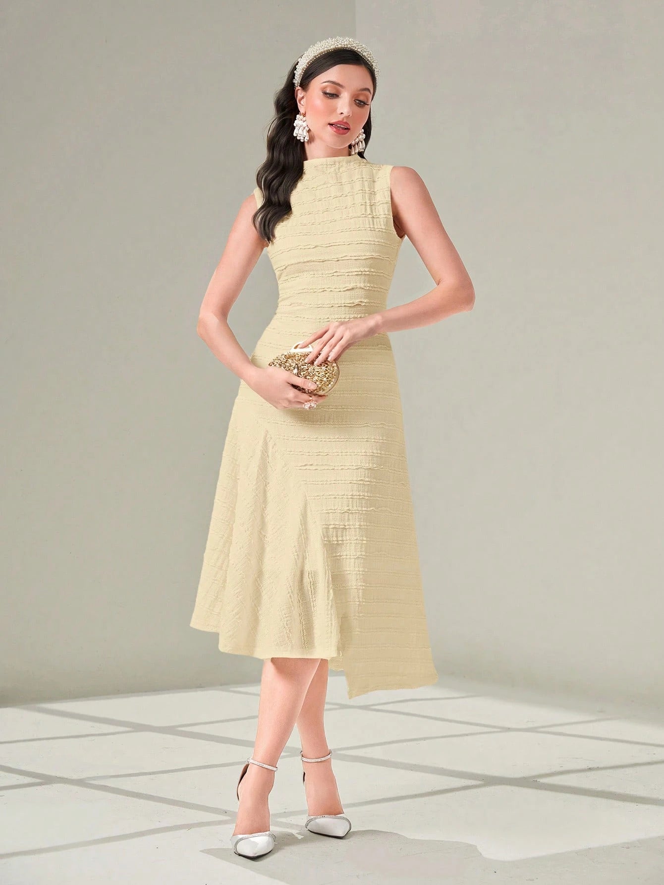 Woman wearing a light yellow dress with a plain background