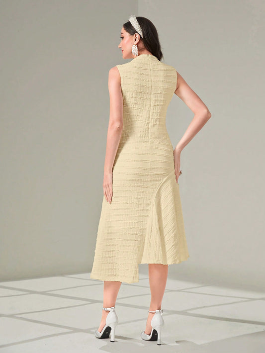 Woman wearing a light yellow dress with a textured pattern on a neutral background