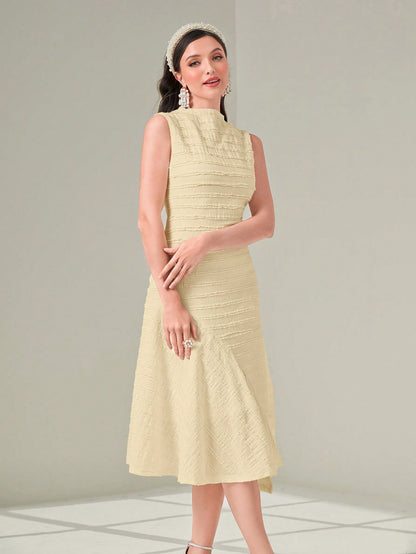 Woman wearing a light yellow dress with a textured pattern on a plain background