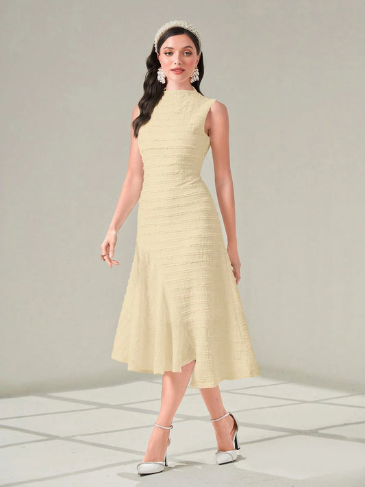 Woman wearing a light yellow dress with a plain background
