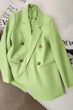 Light green blazer on a mannequin against a neutral background