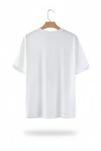 White t-shirt on a wooden hanger against a gray background
