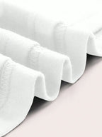 White ruffled fabric on a light gray background
