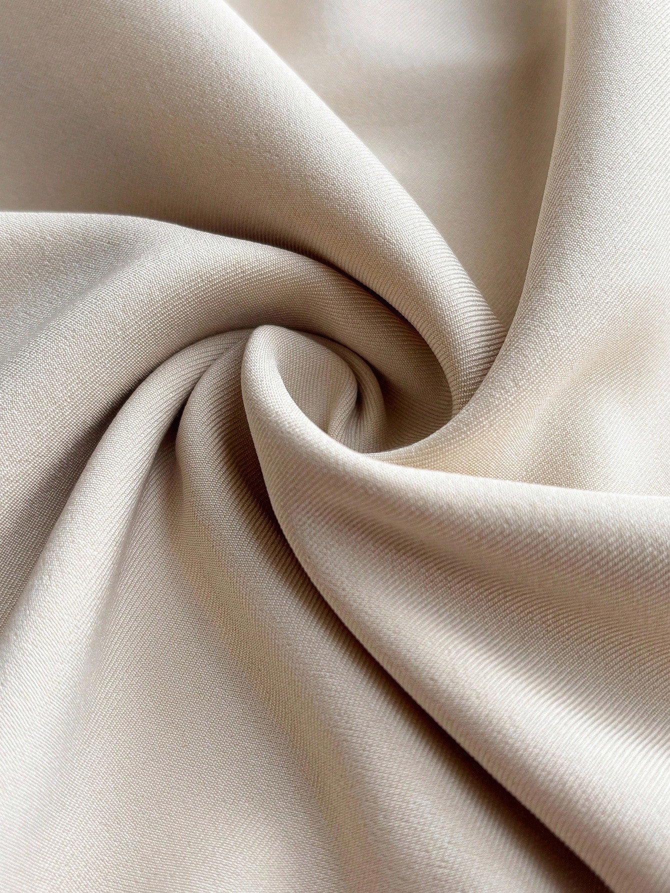 Close-up of beige fabric with folds