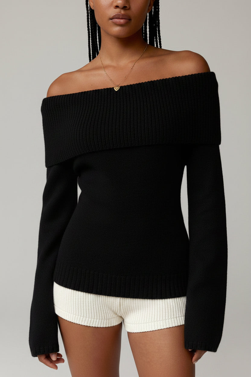 Black off-shoulder sweater worn by a model on a gray background
