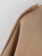 Close-up of a beige fabric texture on a light background