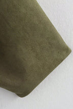 Close-up of a green fabric texture on a white background