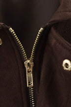 Close-up of a gold zipper on a dark brown jacket