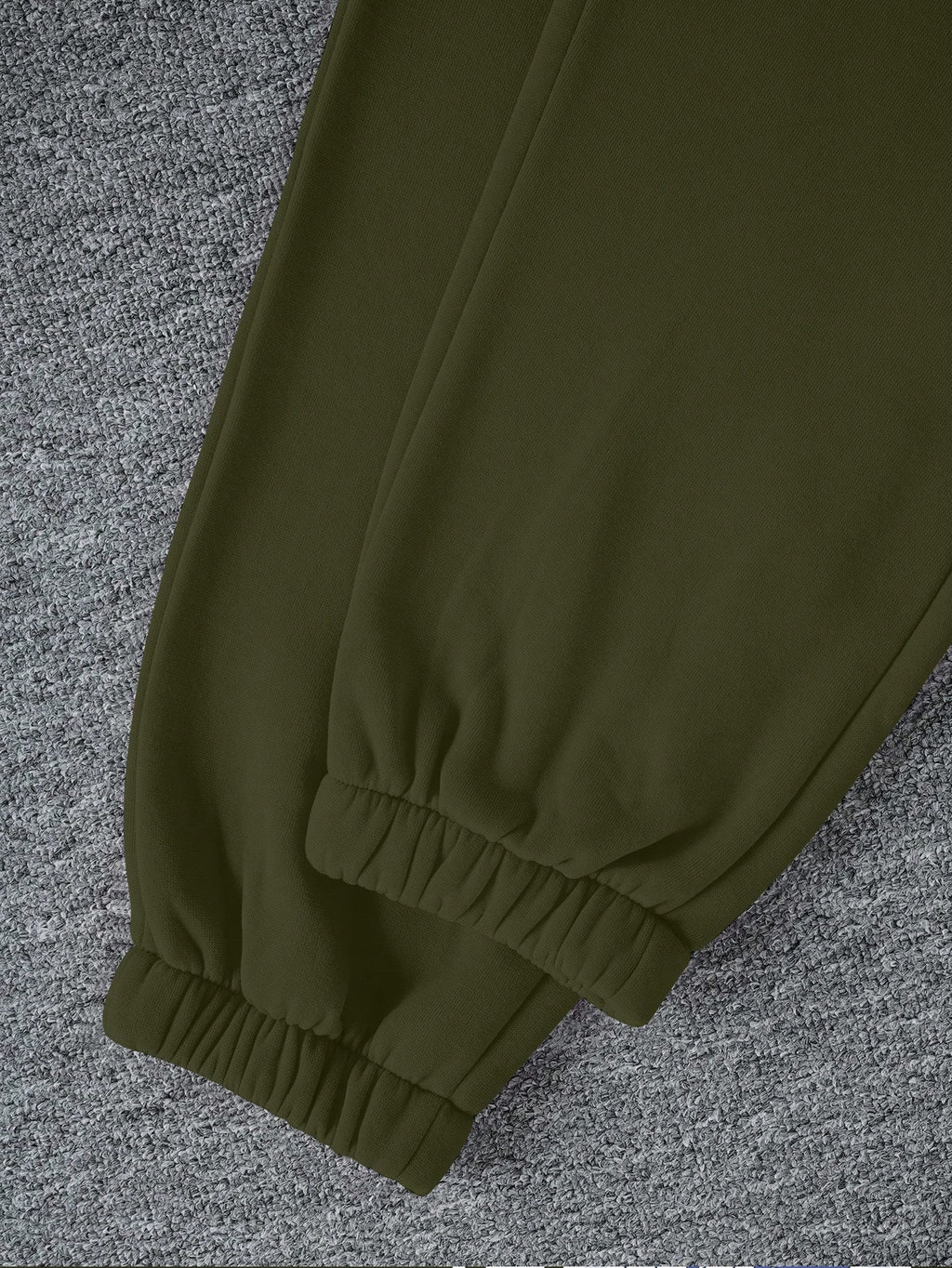 Green pants on a textured gray surface