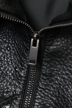 Close-up of a black leather jacket zipper