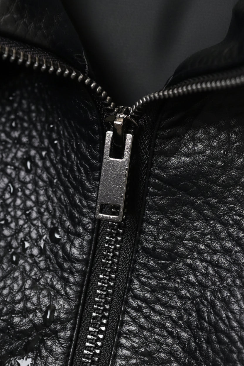 Close-up of a black leather jacket zipper