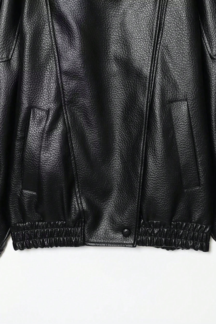 Close-up of a black leather jacket on a white background