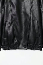 Close-up of a black leather jacket on a white background