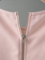 Close-up of a pink jacket with a zipper on a gray background
