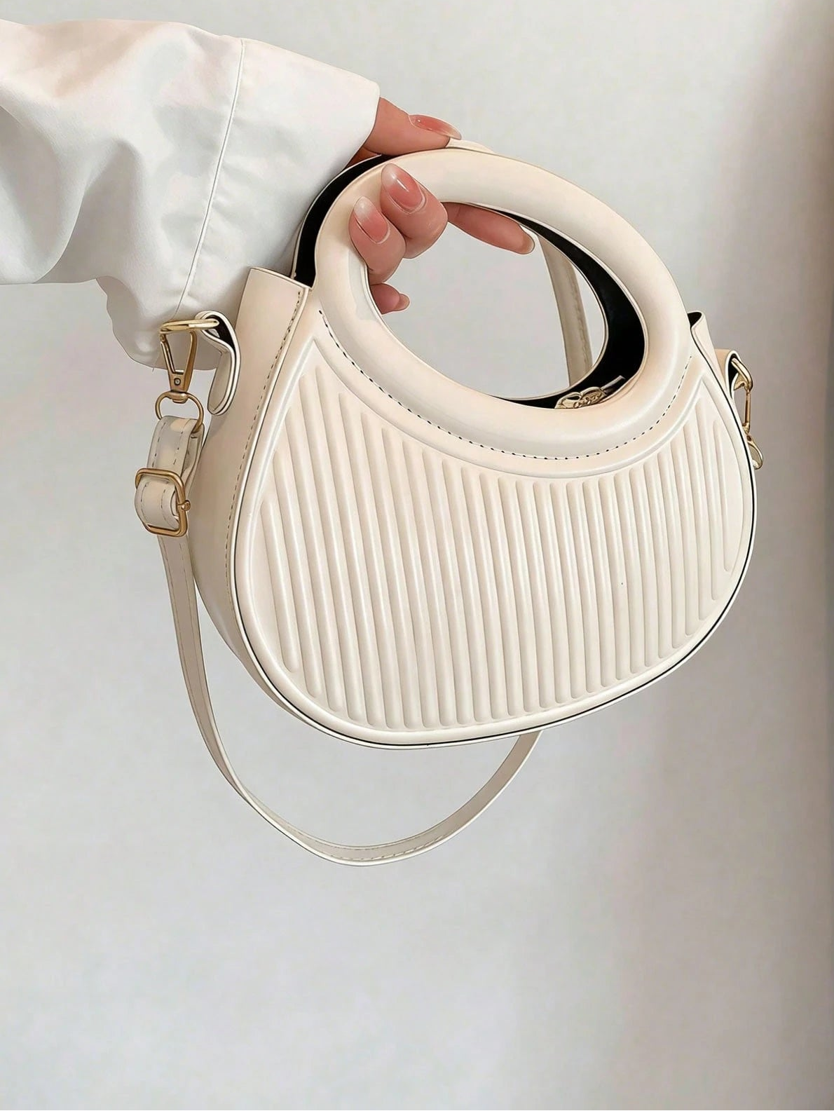 White ribbed handbag with a strap, held by a hand against a light background, branded 'Sensa Chic'.