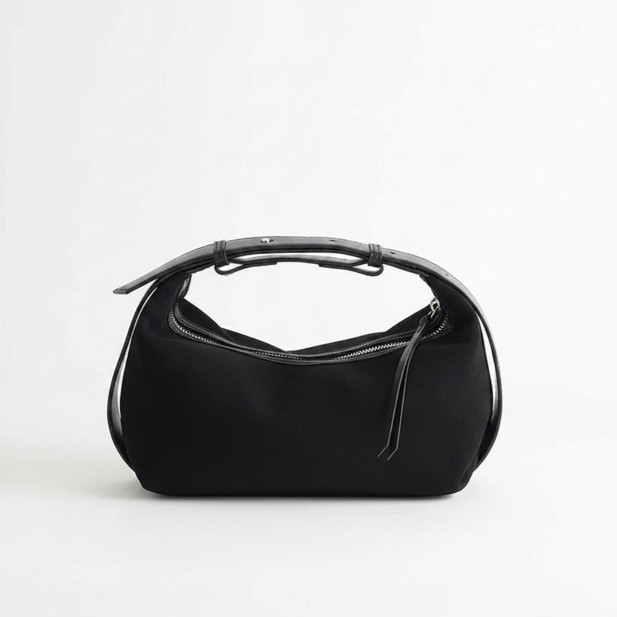 Black handbag with a reflective silver top on a white background